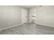 Living Room with door to kitchen and wood-look floors at 10436 W Devonshire Ave, Phoenix, AZ 85037