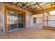 Covered screened patio with tile flooring and access to yard at 10436 W Devonshire Ave, Phoenix, AZ 85037