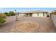 Spacious backyard with gravel, mature trees, and patio at 10737 W Hutton Dr, Sun City, AZ 85351