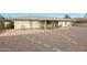 Backyard with covered patio, gravel, and brick walkways at 10737 W Hutton Dr, Sun City, AZ 85351