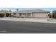 Ranch style home with attached garage and well-manicured lawn at 10737 W Hutton Dr, Sun City, AZ 85351