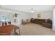 Living room with tile floors, sectional sofa, and view to kitchen at 10737 W Hutton Dr, Sun City, AZ 85351