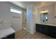 Spa-like bathroom with double sinks, walk-in shower, and dark cabinets at 11615 S 211Th Ln, Buckeye, AZ 85326