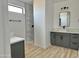 Bathroom with gray vanity, white marble shower, and modern fixtures at 11615 S 211Th Ln, Buckeye, AZ 85326