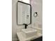 Modern bathroom with a white sink, black matte faucet, and framed mirror at 11615 S 211Th Ln, Buckeye, AZ 85326