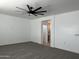 Bright bedroom with ceiling fan and plush carpeting at 11615 S 211Th Ln, Buckeye, AZ 85326