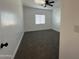 Bright bedroom with grey carpet and ceiling fan at 11615 S 211Th Ln, Buckeye, AZ 85326