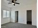 Bright bedroom with gray carpet and a ceiling fan at 11615 S 211Th Ln, Buckeye, AZ 85326