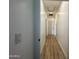 Bright hallway with light wood flooring and white walls at 11615 S 211Th Ln, Buckeye, AZ 85326