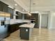 Modern kitchen with gray cabinets, an island, and stainless steel appliances at 11615 S 211Th Ln, Buckeye, AZ 85326