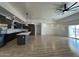 Open concept kitchen with island, stainless steel appliances, and dark cabinetry at 11615 S 211Th Ln, Buckeye, AZ 85326