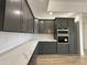 Modern kitchen featuring dark cabinetry and white quartz countertops at 11615 S 211Th Ln, Buckeye, AZ 85326