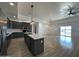 Open concept kitchen and dining area with luxury vinyl flooring and modern lighting at 11615 S 211Th Ln, Buckeye, AZ 85326