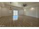 Spacious living room with vinyl flooring and sliding glass doors at 11615 S 211Th Ln, Buckeye, AZ 85326