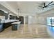 Open living room and kitchen area with luxury vinyl plank flooring at 11615 S 211Th Ln, Buckeye, AZ 85326