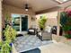 Cozy covered patio with comfortable seating area, ceiling fan, and access via glass slider at 1233 E Redfield Rd, Phoenix, AZ 85022