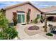 The home's stucco exterior is adorned with blooming vines, desert landscaping, and a covered patio at 1233 E Redfield Rd, Phoenix, AZ 85022