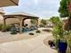 Landscaped backyard featuring a cozy gazebo with comfortable seating and a paved pathway at 1233 E Redfield Rd, Phoenix, AZ 85022