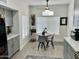 Bright breakfast nook with a round table, overhead lighting, and cabinetry with counter space at 1233 E Redfield Rd, Phoenix, AZ 85022