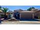 Tan house with tile roof, attached garage, and desert landscaping at 1233 E Redfield Rd, Phoenix, AZ 85022