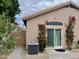 The home's stucco exterior is adorned with blooming vines, desert landscaping, and a sliding glass door at 1233 E Redfield Rd, Phoenix, AZ 85022