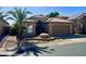 Tan house with tile roof, attached garage, and desert landscaping at 1233 E Redfield Rd, Phoenix, AZ 85022