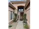 Close-up of the front entryway featuring a secure screen door and decorative side vegetation at 1233 E Redfield Rd, Phoenix, AZ 85022