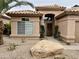 Inviting single-story home featuring a desert-landscaped front yard and an arched entryway at 1233 E Redfield Rd, Phoenix, AZ 85022