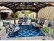 Charming covered gazebo featuring stylish outdoor furniture and a welcoming blue patterned rug at 1233 E Redfield Rd, Phoenix, AZ 85022