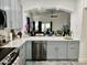 A modern kitchen with stainless steel appliances and marble countertops flows into the dining area at 1233 E Redfield Rd, Phoenix, AZ 85022