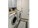 Bright laundry room featuring modern washer and dryer and cabinets for organized storage at 1233 E Redfield Rd, Phoenix, AZ 85022