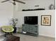 Living area featuring neutral walls, tile floors, and a decorative entertainment center at 1233 E Redfield Rd, Phoenix, AZ 85022