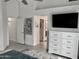 Bright main bedroom with a ceiling fan, white dresser, and doorway to the main bathroom at 1233 E Redfield Rd, Phoenix, AZ 85022