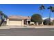 Single-story home with desert landscaping, two-car garage, and palm trees at 14226 W Via Montoya --, Sun City West, AZ 85375