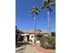 View of the front of the house with mature palm trees and landscaping at 14226 W Via Montoya --, Sun City West, AZ 85375