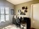 Home office features built-in shelving, a desk, and large window with plantation shutters at 14226 W Via Montoya --, Sun City West, AZ 85375