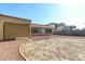 Large backyard with gravel and a covered patio area at 14400 N 136Th Ln, Surprise, AZ 85379