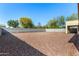 Large backyard with gravel and a covered patio area at 14400 N 136Th Ln, Surprise, AZ 85379