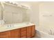 Bathroom boasts double sinks, a tub, and a shower at 14400 N 136Th Ln, Surprise, AZ 85379