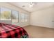 Bedroom with two windows and ceiling fan at 14400 N 136Th Ln, Surprise, AZ 85379