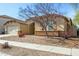 One-story house with a two-car garage, landscaping, and a neutral color palette at 14400 N 136Th Ln, Surprise, AZ 85379