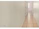 Clean hallway with light-colored tile floors and access to other rooms at 14400 N 136Th Ln, Surprise, AZ 85379