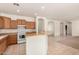 Spacious kitchen with light wood cabinets and a kitchen island at 14400 N 136Th Ln, Surprise, AZ 85379