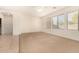 Living room with neutral carpet, ceiling fan and large windows at 14400 N 136Th Ln, Surprise, AZ 85379