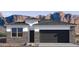 Single-story home with a two-car garage and mountain views at 15397 W Hackamore Dr, Surprise, AZ 85387