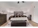 Main bedroom with gray upholstered headboard and dark brown dresser at 15806 N 45Th Pl, Phoenix, AZ 85032