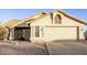 Tan single story house with a two car garage at 169 S Comanche Dr, Chandler, AZ 85224