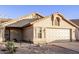 Tan single story house with a two car garage at 169 S Comanche Dr, Chandler, AZ 85224