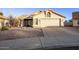 Tan house with a two-car garage and desert landscaping at 169 S Comanche Dr, Chandler, AZ 85224