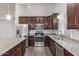 Modern kitchen with granite countertops and wood cabinets at 169 S Comanche Dr, Chandler, AZ 85224